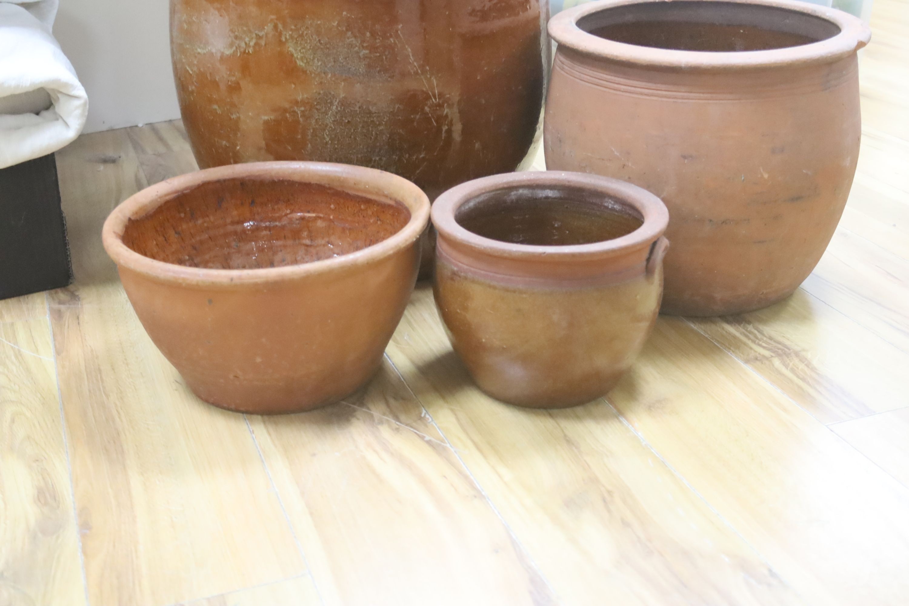 Four Sussex terracotta pots, tallest 40cm